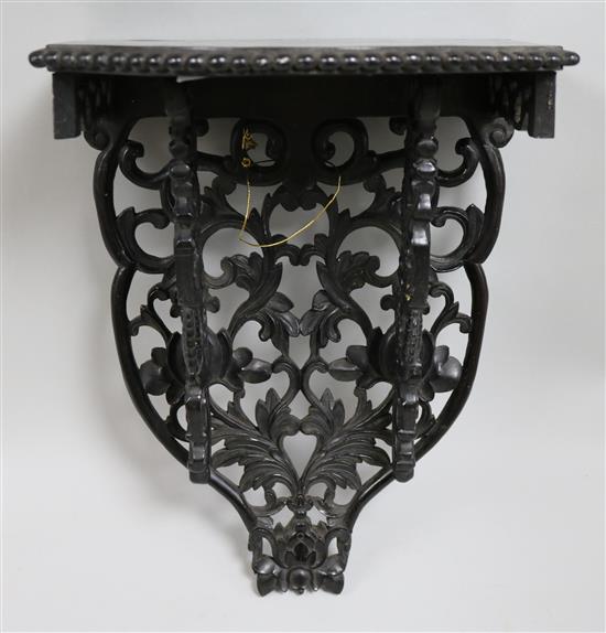 A carved ebony wall bracket